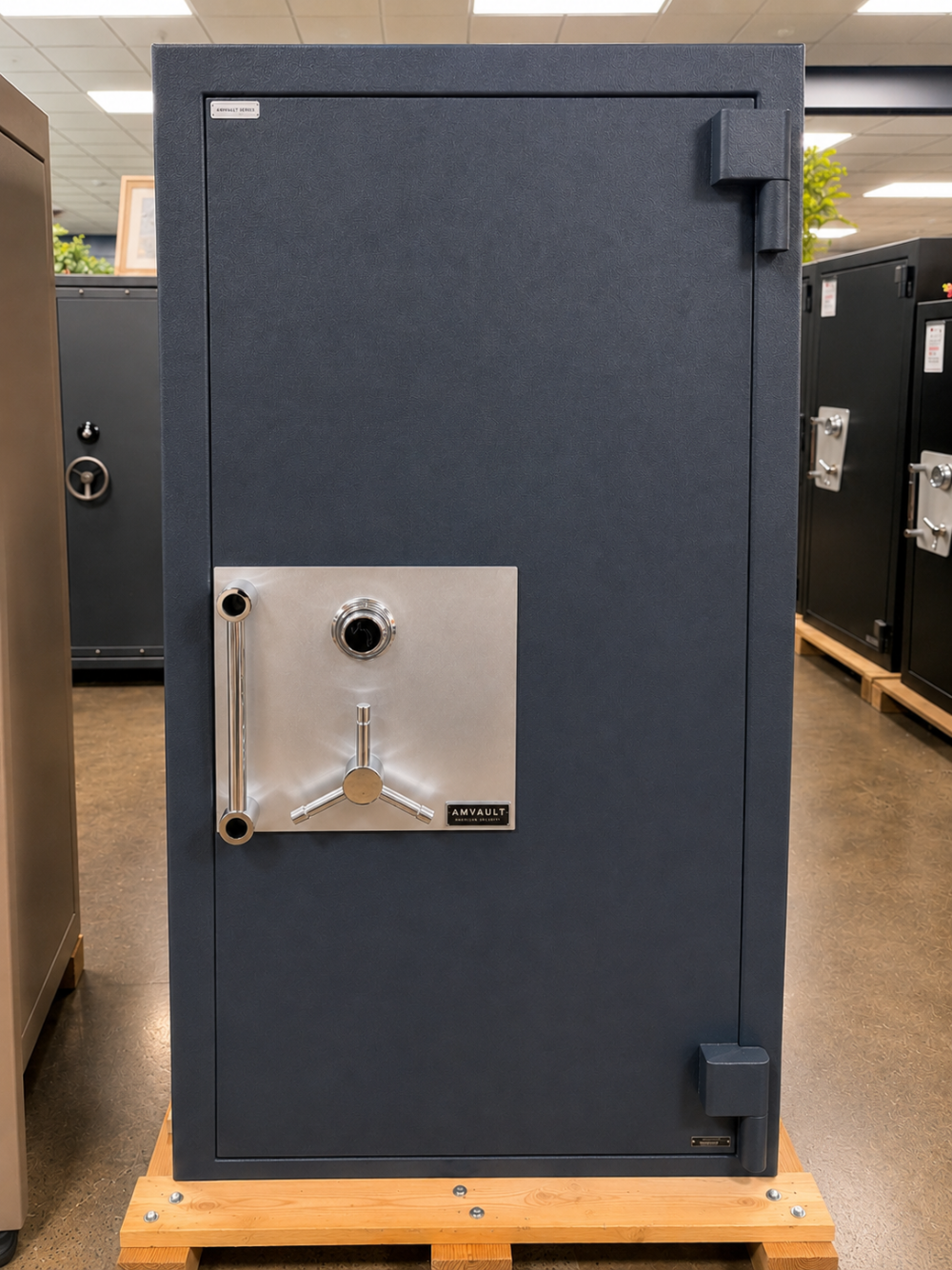 A navy AMVAULT high-security residential safe with a stainless steel dial, spoked handle, and certified lock package on the Norcal Safe and Vault showroom floor
