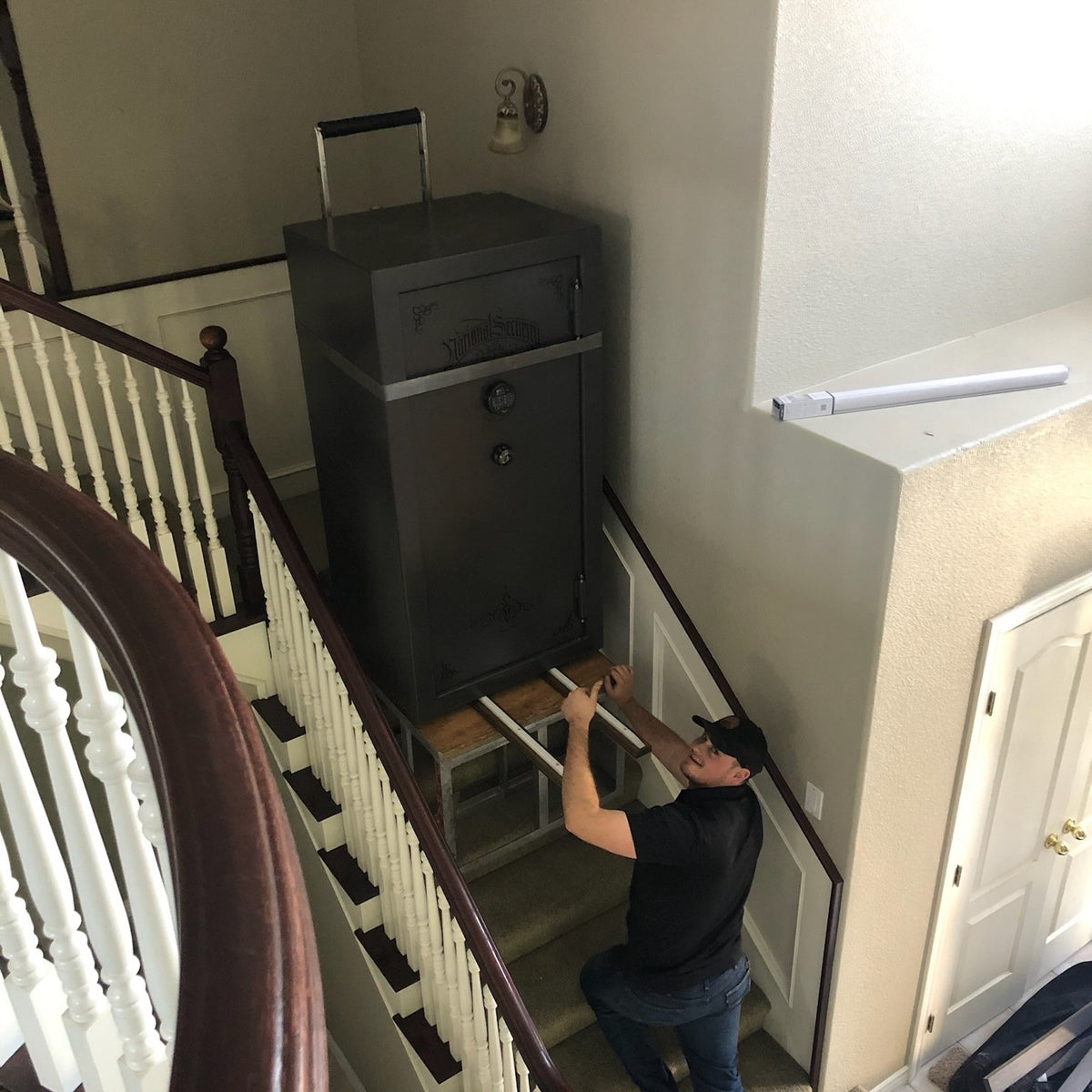 A safe set in place at the top of a curved residential staircase