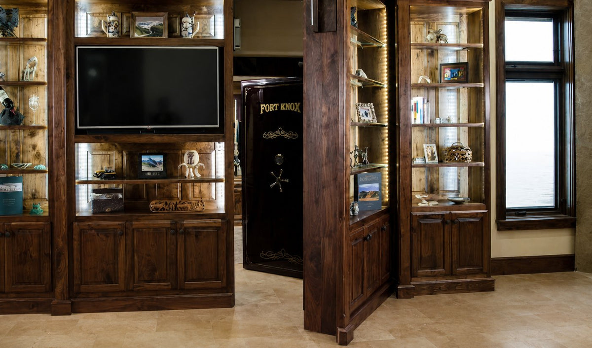 A Fort Knox vault door concealed behind a rotating built-in bookcase in a private NorCal residence, with no identifying detail of the property