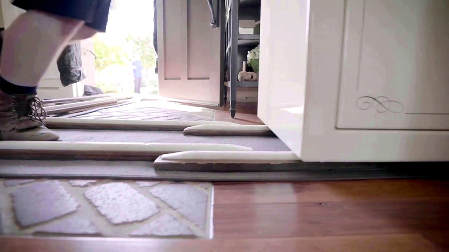 Hardboard floor-protection panels laid through a doorway before the safe enters