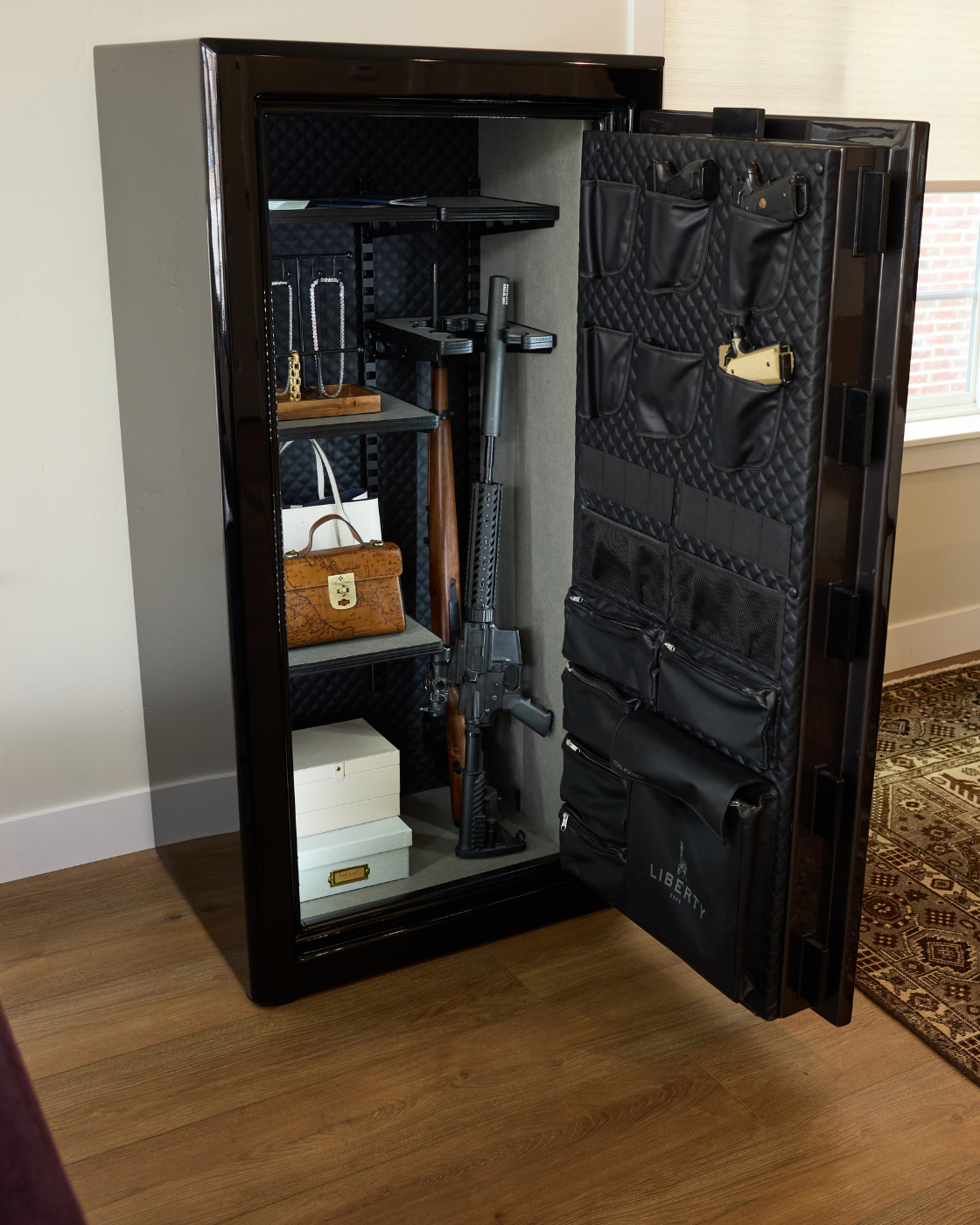 Open Liberty safe with documents, valuables, and firearms organized inside