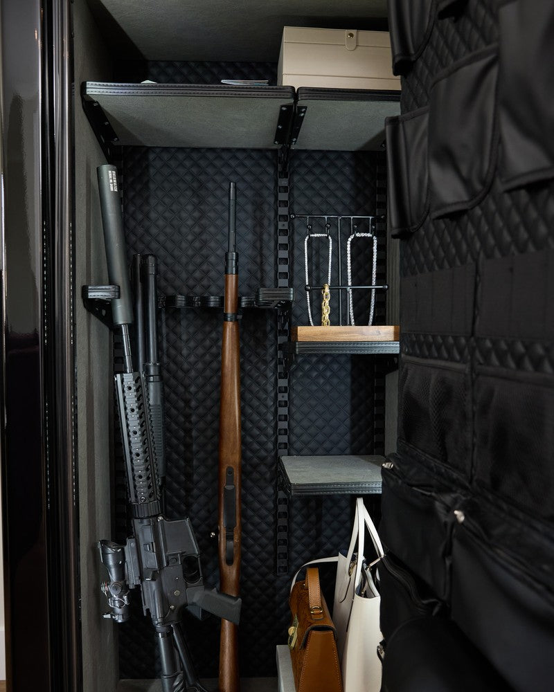 Liberty safe interior showing firearms, jewelry chains, and handbags, the exact assets organized burglary crews target