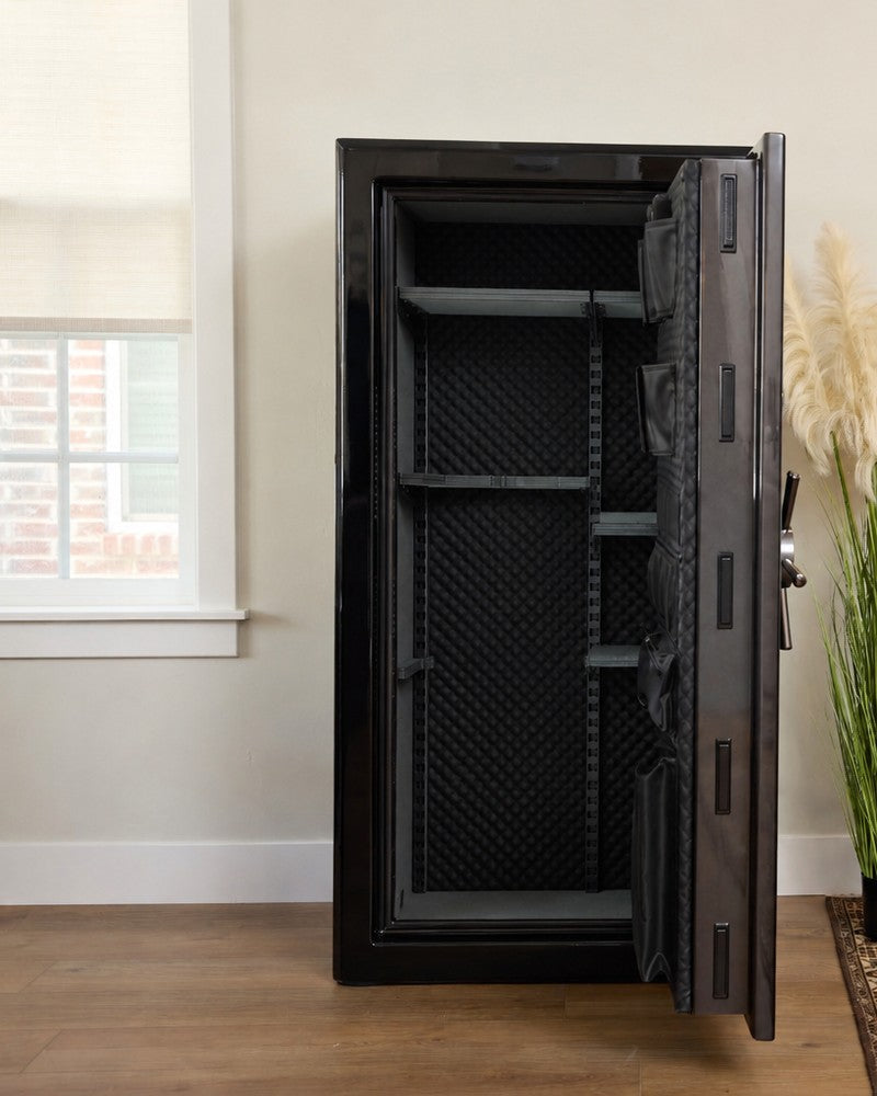 Open empty gun safe in a residential living room, every shelf cleared, nothing left inside