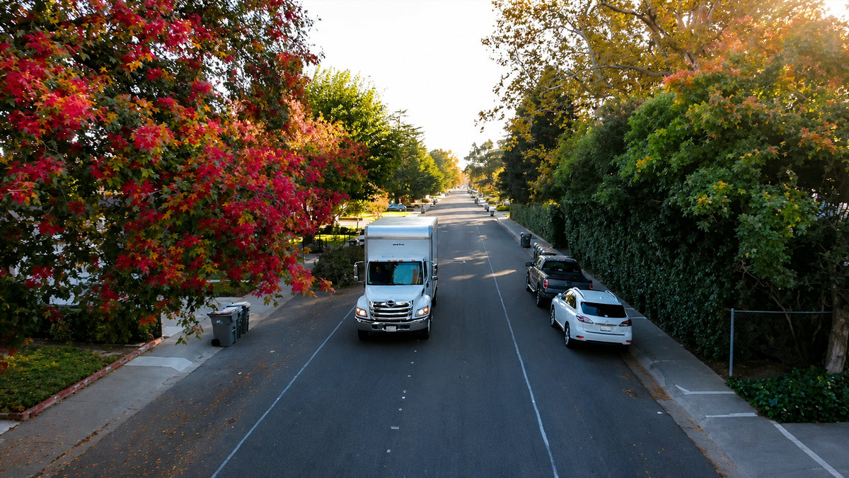 An unmarked white box truck on a quiet tree-lined Northern California residential street