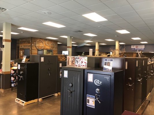 Row of black safes in a showroom with 'Colt' branding.