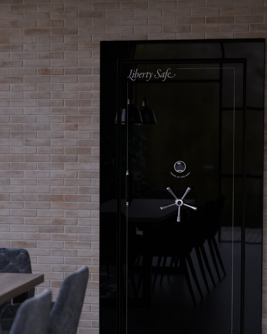 A black Liberty vault door with a five-spoke handle and electronic lock, recessed into the brick wall of a Northern California loft home